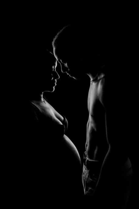 Photo artistique de grossesse en clair-obscur au studio
